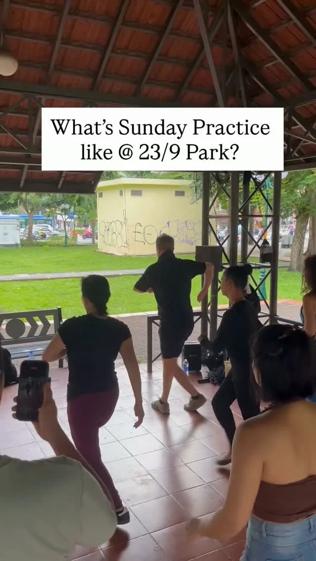 Group of dancers practising salsa in an open pavilion at 23/9 Park, Saigon
