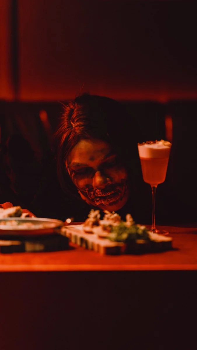 Volar Halloween promotional image for The Red Room showing a demon-themed dining and cocktail scene.