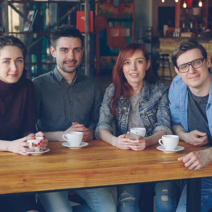 Organizer promotional image showing four people with coffee, used for the weekly English Club; it does not depict or verify this dated gathering.