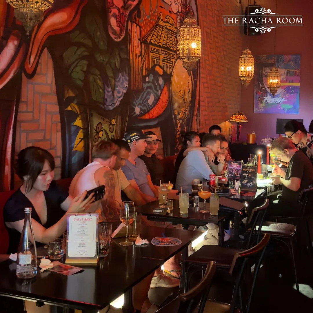 The Racha Room dining space at 105–107 Xuan Thuy, with its mural, pendant lights and tables.