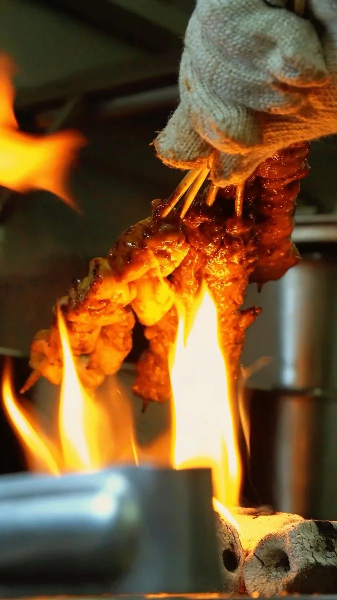 Grilled skewers over flames in Wok Of Love Halloween announcement