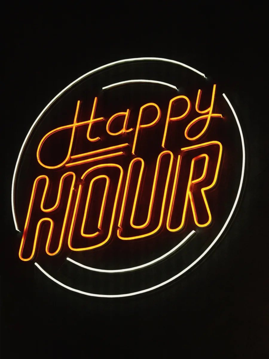 Happy Hour neon sign at Symposium Bar