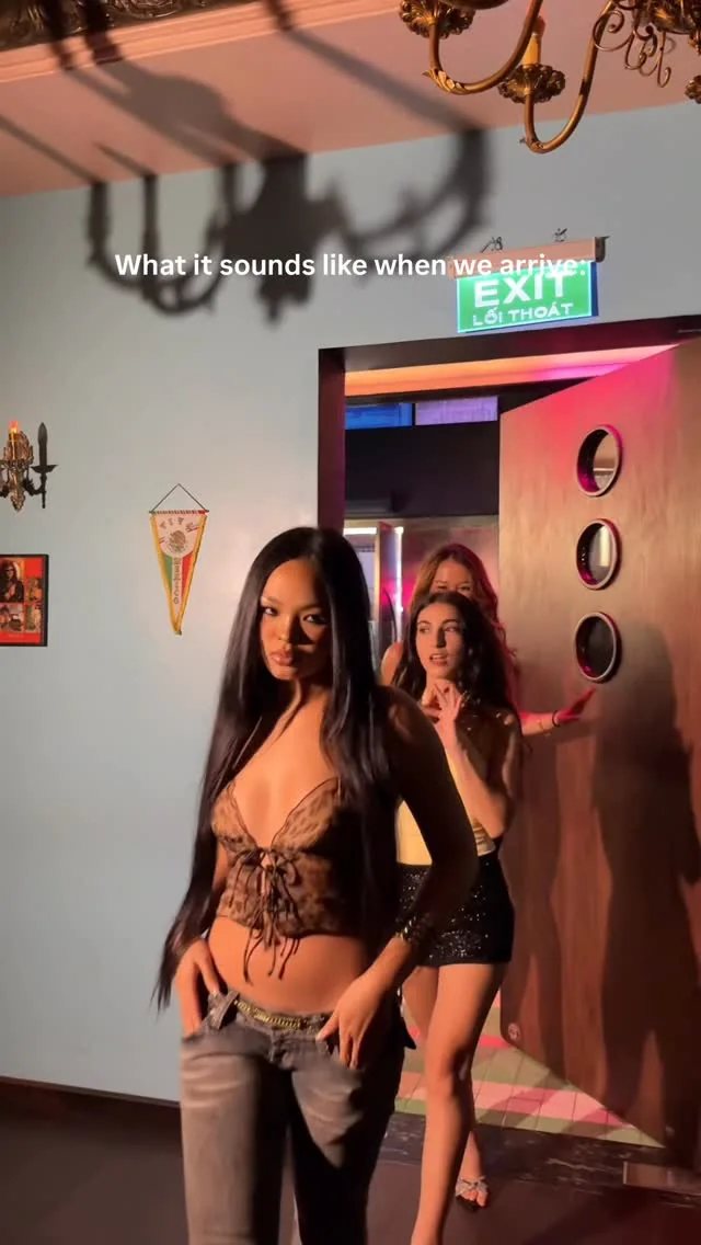 Women arriving at Salon Saigon nightclub entrance, text reads: What it sounds like when we arrive