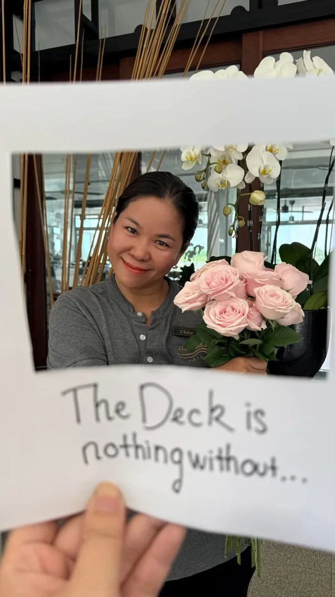 The Deck team member holding flowers in the venue’s Vietnamese Women’s Day announcement; illustrative image, with no depiction of DJ Avery.
