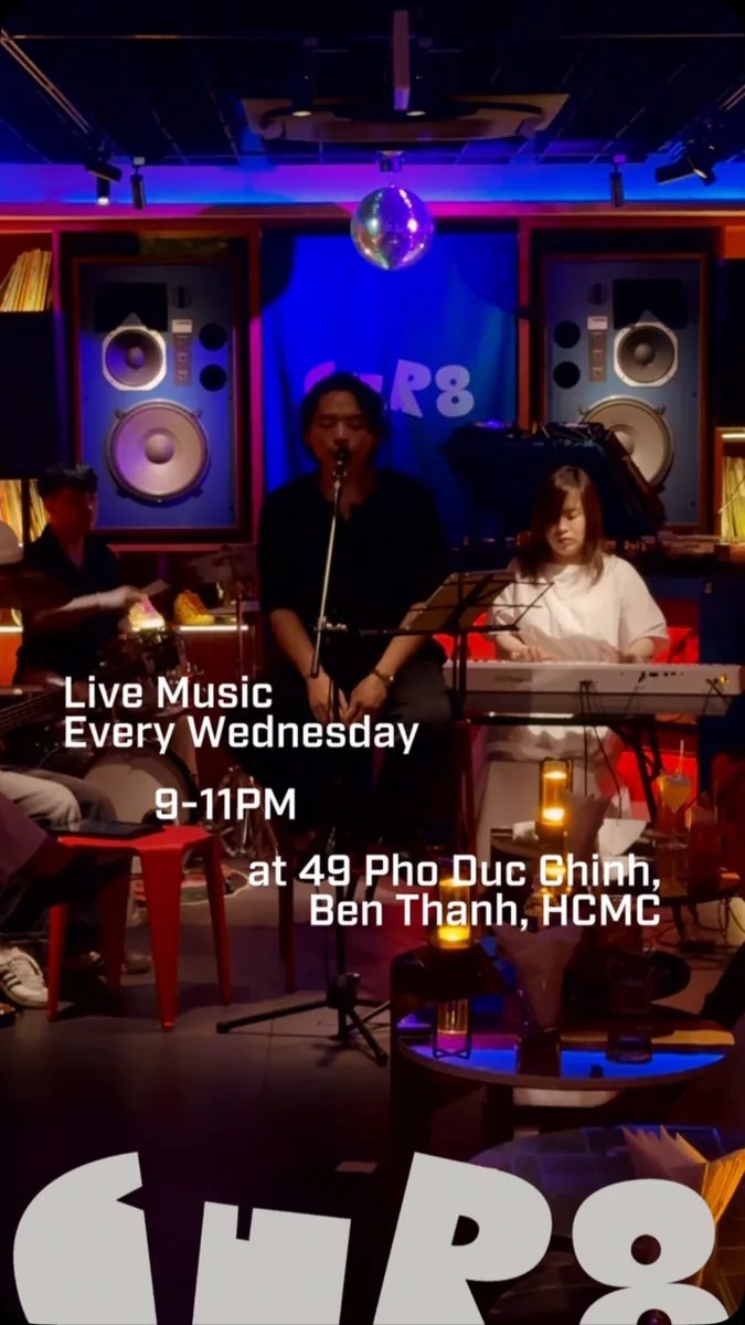 Live music performance at CUR8 Saigon with text overlay: Live Music Every Wednesday 9-11PM at 49 Pho Duc Chinh, Ben Thanh, HCMC. Shared image covering both Oct 22 and Oct 29 2026 occurrences.