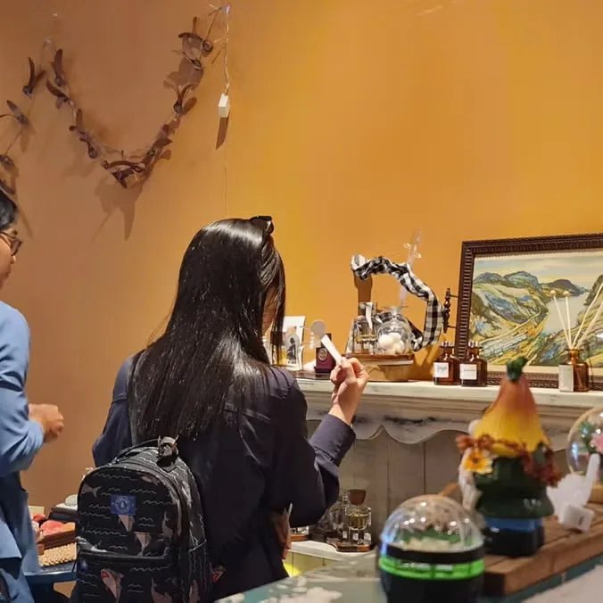 Fragrance products and visitor at Myths, used as event-page imagery for the Chiaro workshop.