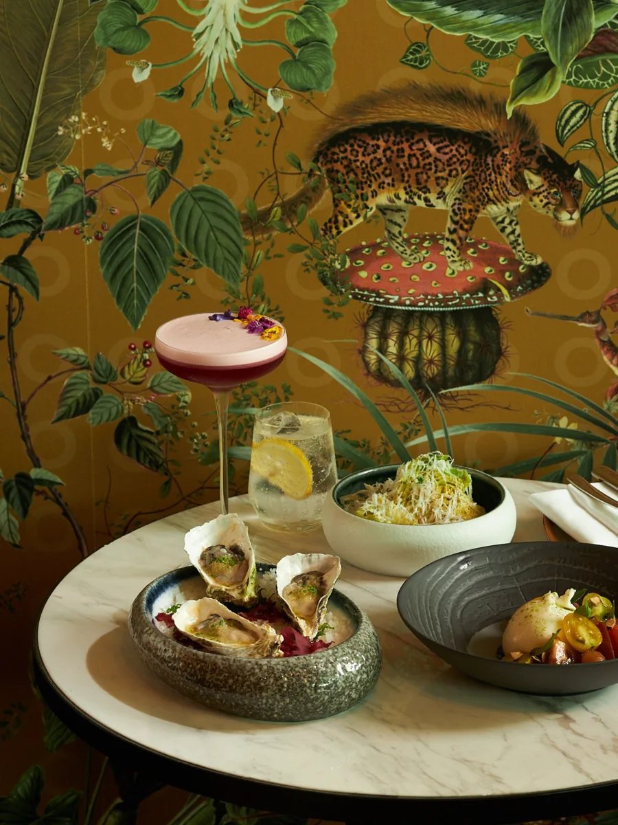 BAR SON promotional photo of cocktails, oysters and food at its 3C Ton Duc Thang branch.